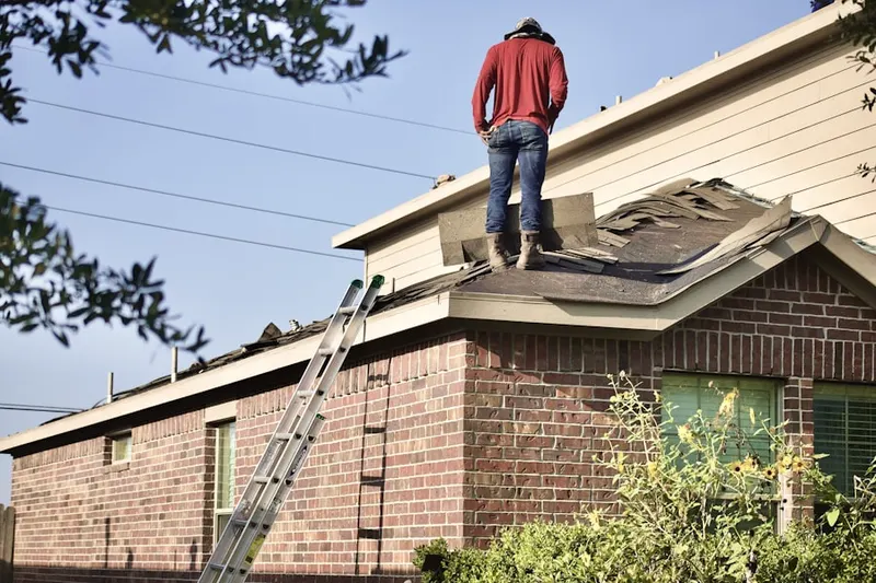 Professional roofer working on a residential roof in Hiawatha Gardens